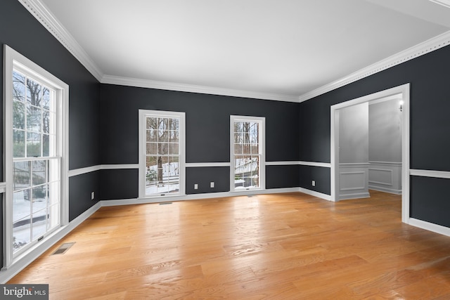 unfurnished room with crown molding and light wood-type flooring