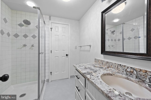 bathroom with walk in shower and vanity