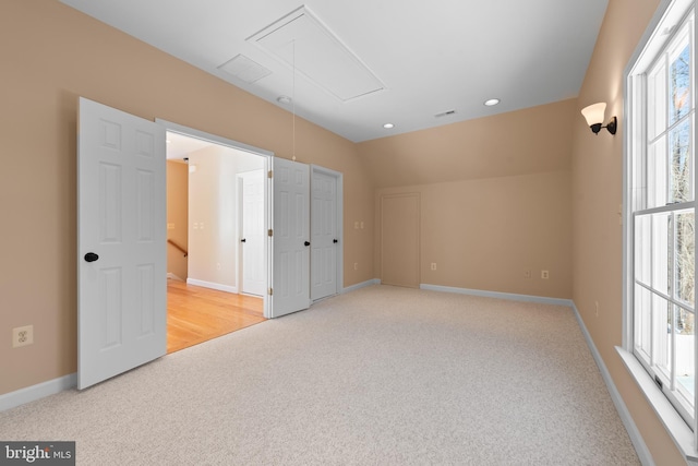 unfurnished room with lofted ceiling and light carpet