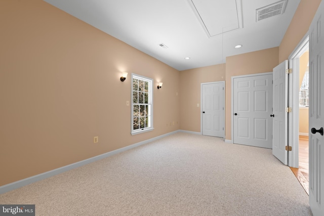 unfurnished bedroom featuring multiple windows and light colored carpet