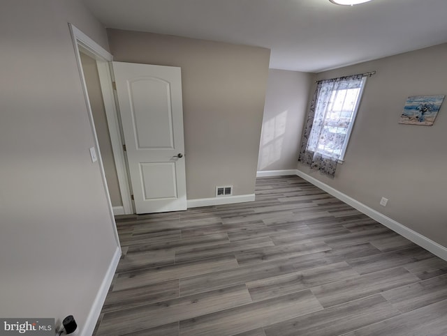 spare room featuring light hardwood / wood-style flooring