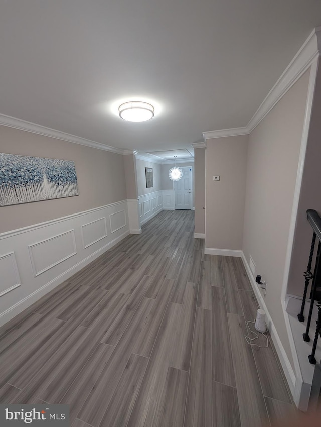 empty room featuring ornamental molding and hardwood / wood-style flooring