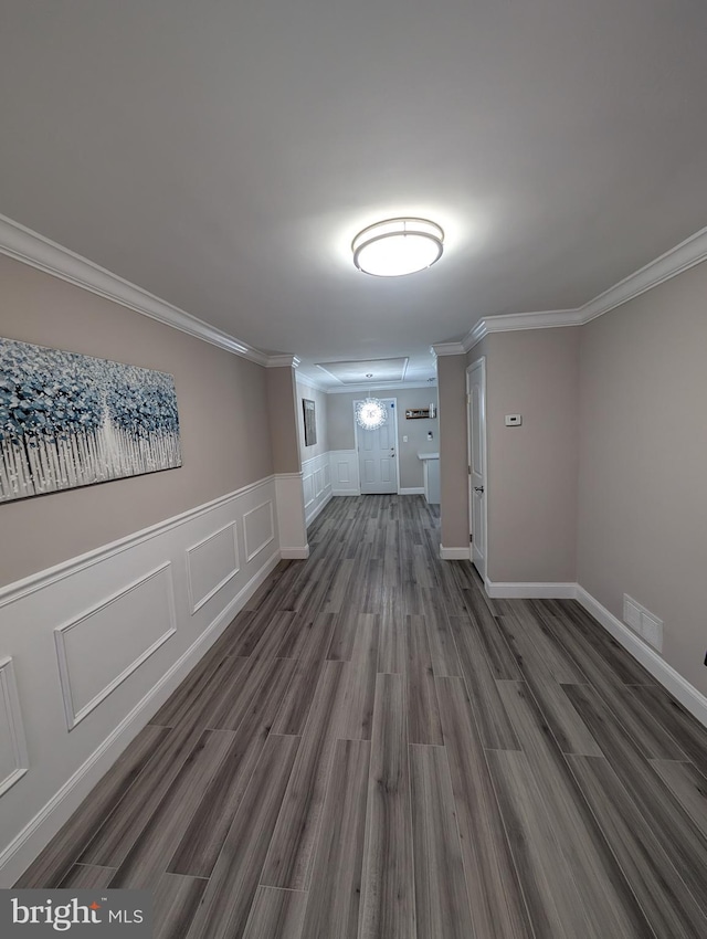 interior space with dark hardwood / wood-style floors and ornamental molding