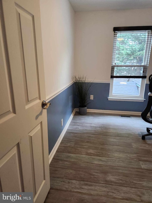 unfurnished room featuring dark wood-type flooring