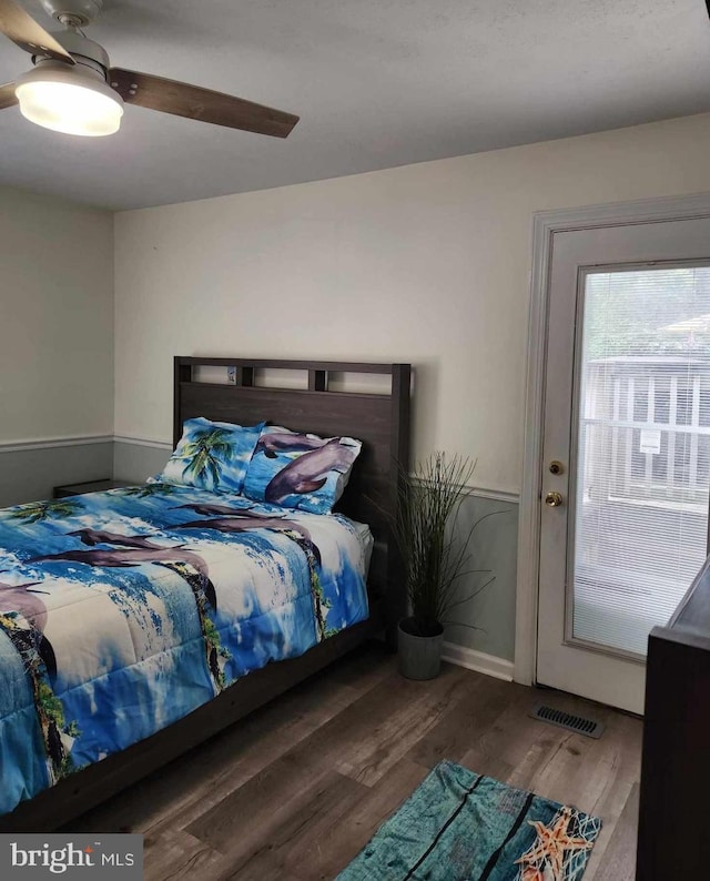 bedroom with dark wood-type flooring and ceiling fan