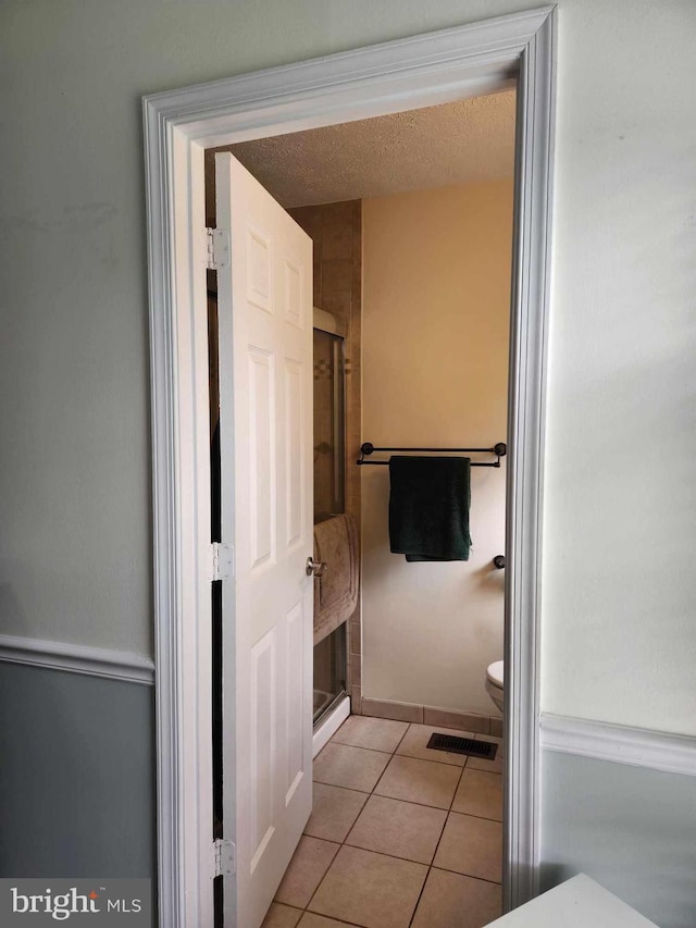 bathroom with tile patterned flooring and toilet