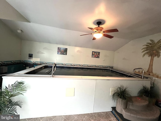 interior space featuring vaulted ceiling and ceiling fan