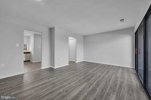 unfurnished living room with dark wood-type flooring