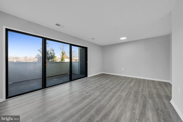 empty room with light hardwood / wood-style flooring