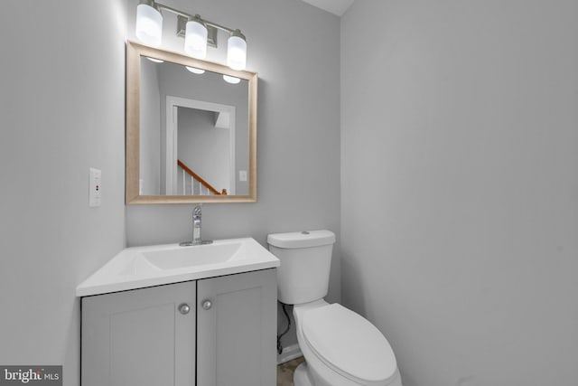 bathroom featuring toilet and vanity