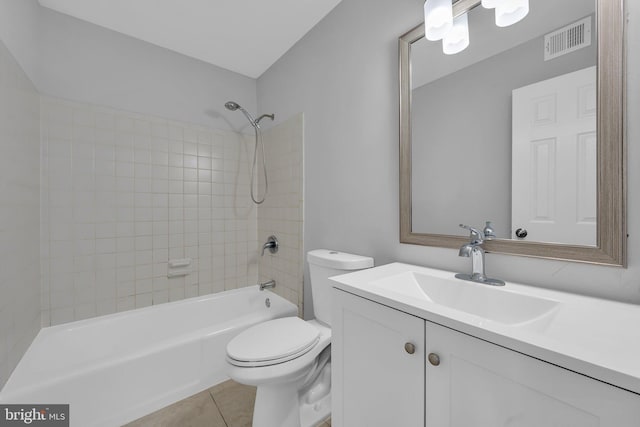 full bathroom featuring tiled shower / bath combo, toilet, tile patterned floors, and vanity