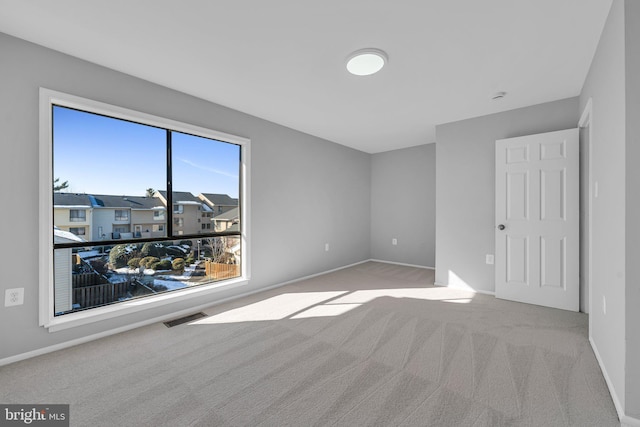 empty room with light colored carpet