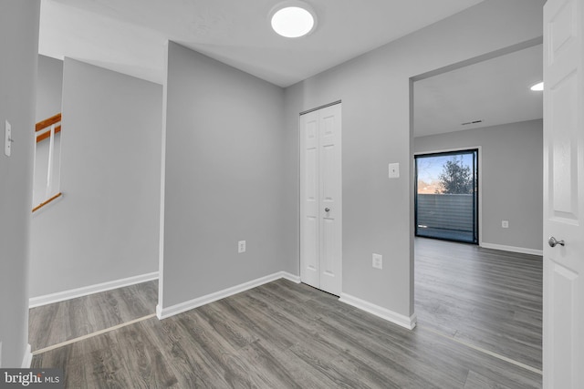 unfurnished room with wood-type flooring