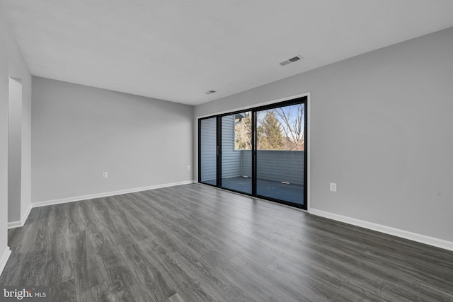 unfurnished room featuring dark wood-type flooring