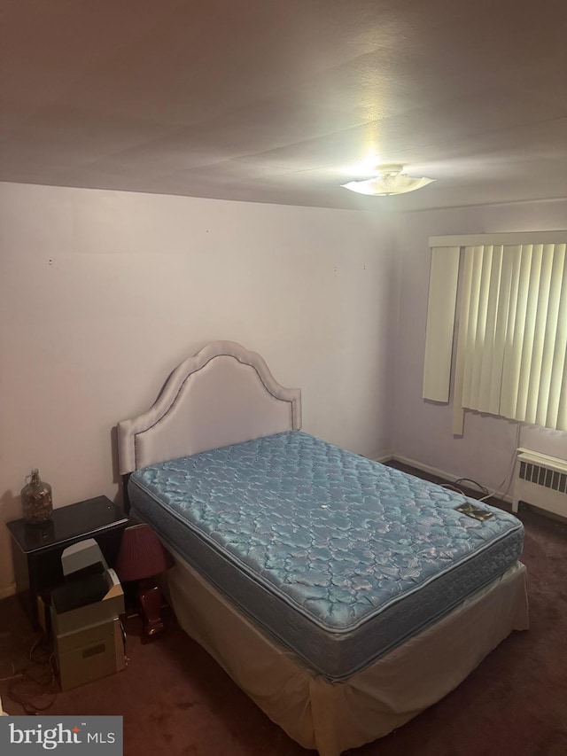 bedroom featuring carpet floors and radiator