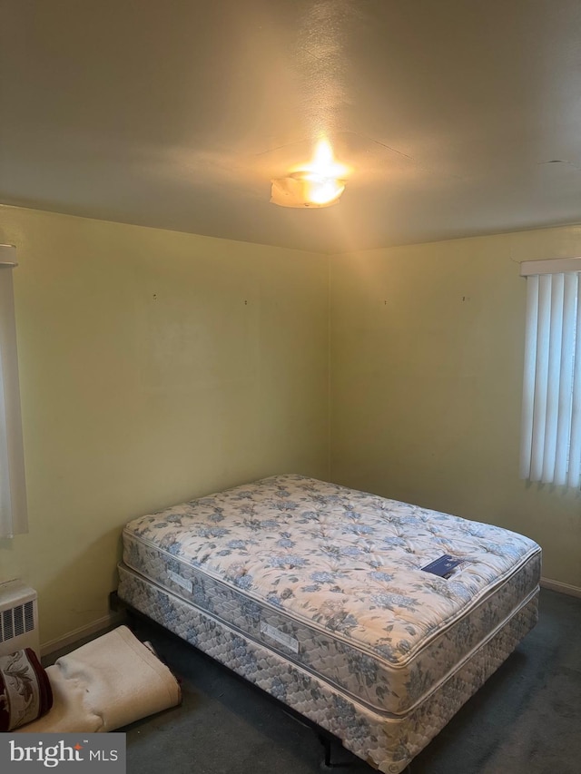 carpeted bedroom featuring radiator heating unit