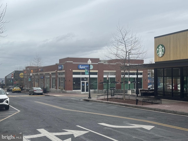 view of building exterior featuring uncovered parking