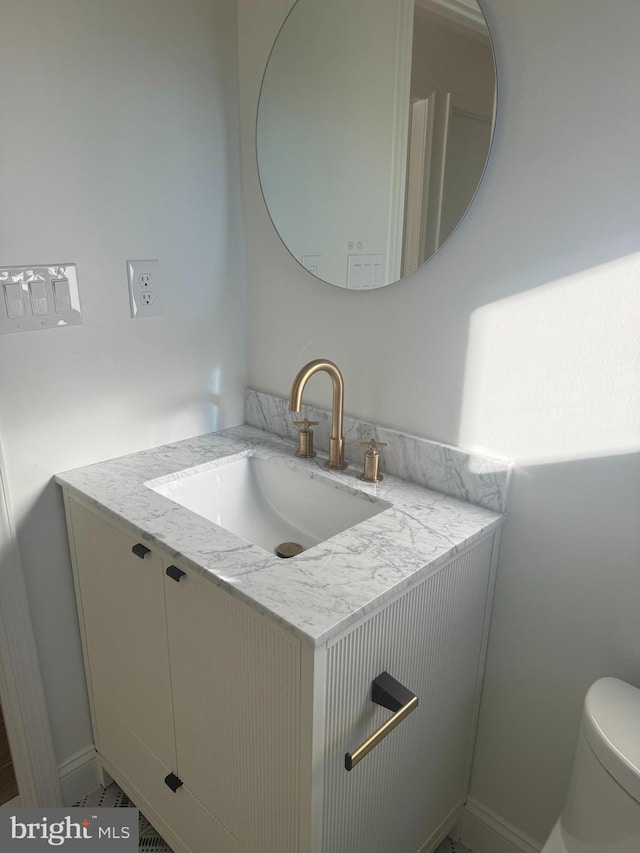 bathroom featuring toilet and vanity