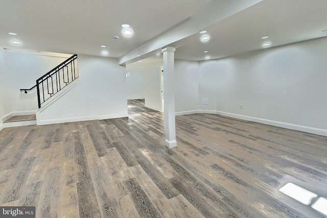 basement with dark hardwood / wood-style flooring