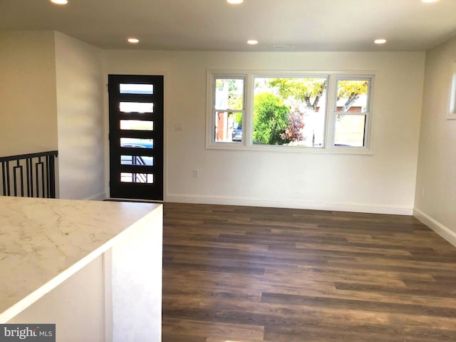 entryway with dark hardwood / wood-style flooring