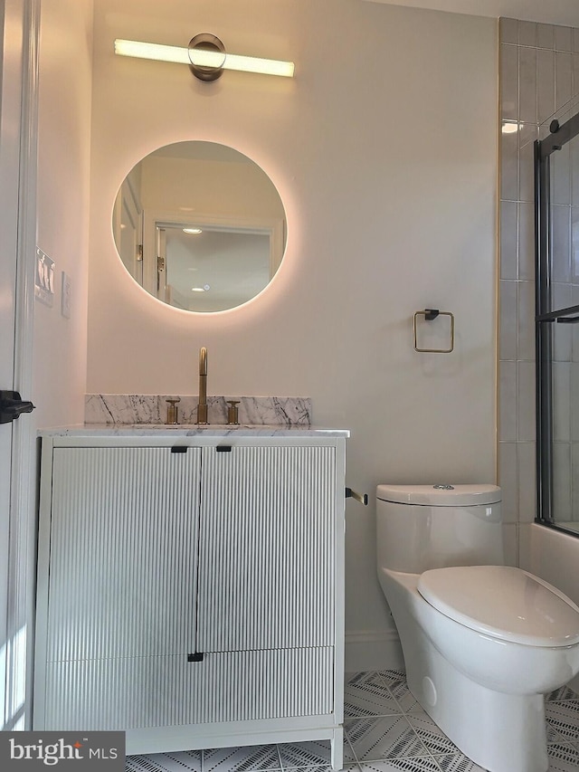 full bathroom with enclosed tub / shower combo, vanity, toilet, and tile patterned flooring