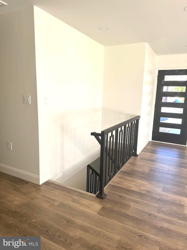 stairway featuring hardwood / wood-style floors