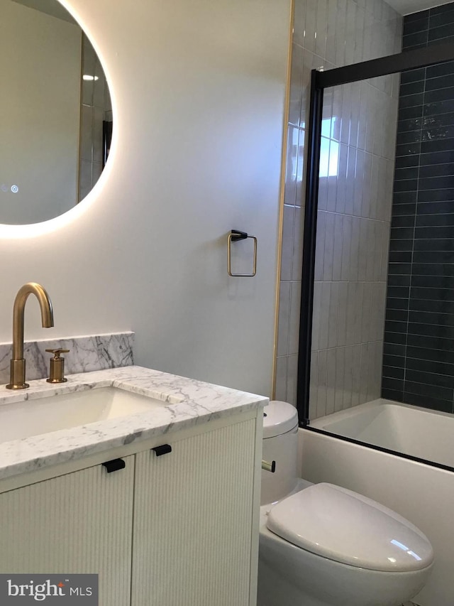 full bathroom with toilet, vanity, and shower / bath combination with glass door