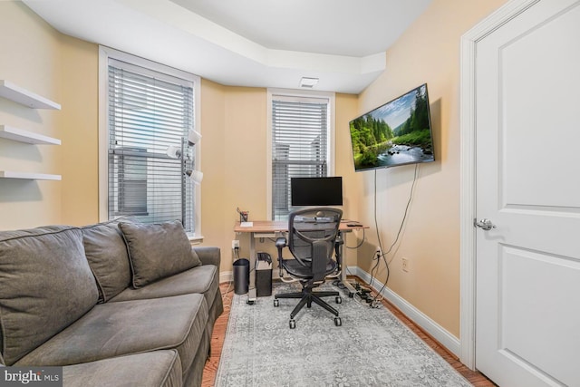 office area with baseboards and wood finished floors