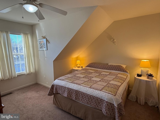 carpeted bedroom with vaulted ceiling and ceiling fan