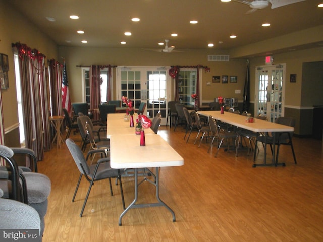 dining room with french doors and light hardwood / wood-style floors