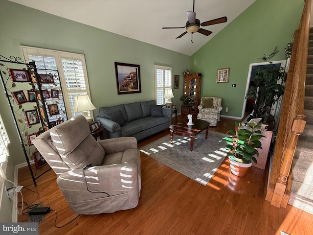 living room with ceiling fan, lofted ceiling, and wood-type flooring