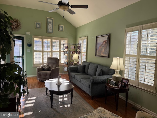 living room with ceiling fan, lofted ceiling, and dark hardwood / wood-style floors