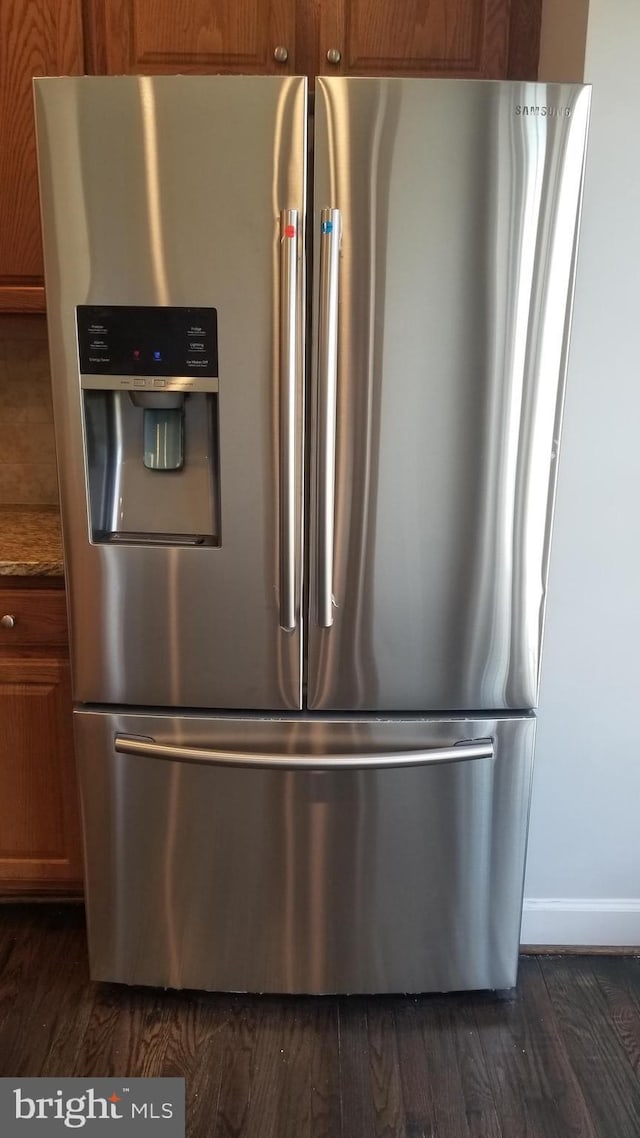 room details featuring stainless steel fridge and dark hardwood / wood-style flooring