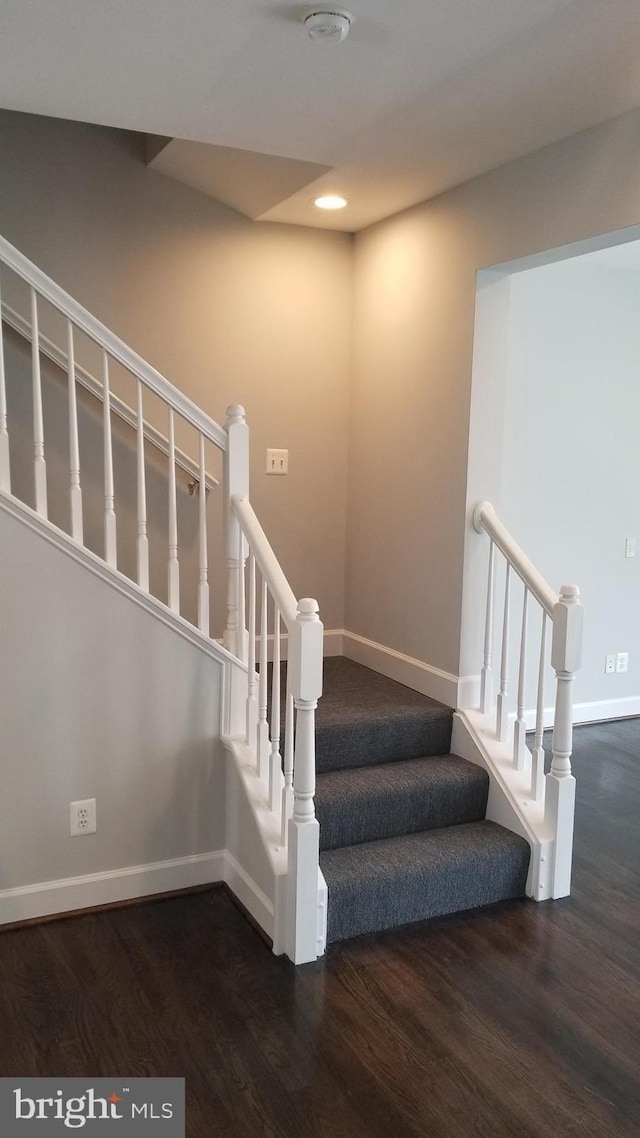 staircase featuring hardwood / wood-style floors