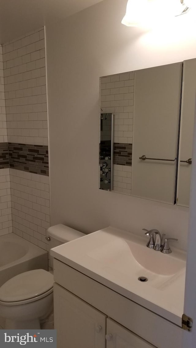 bathroom with toilet and vanity