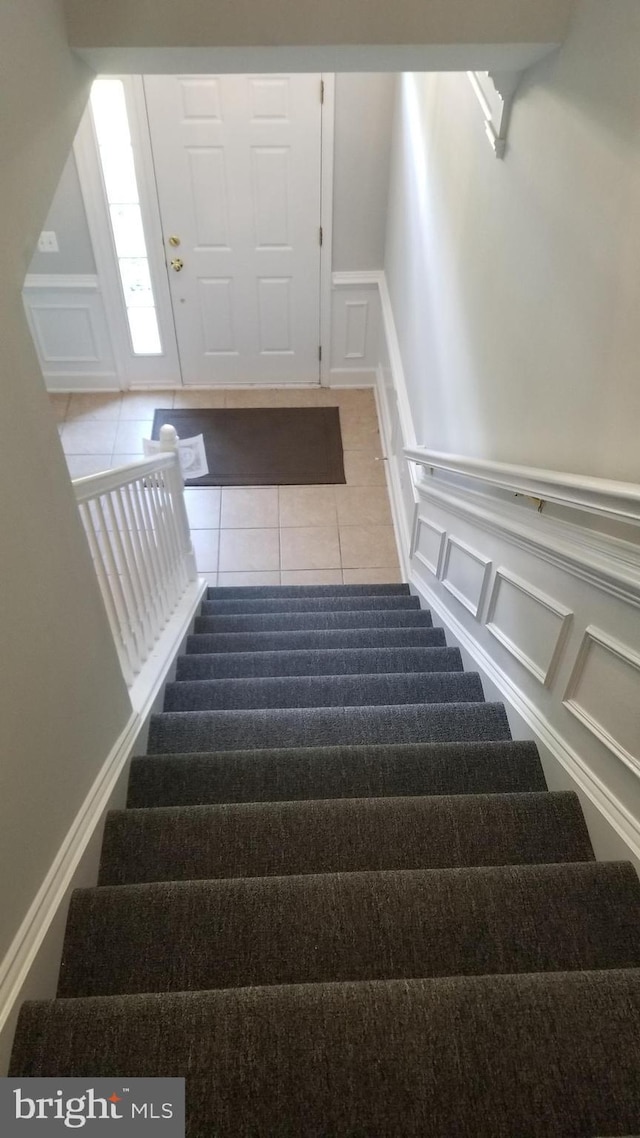 staircase with tile patterned flooring