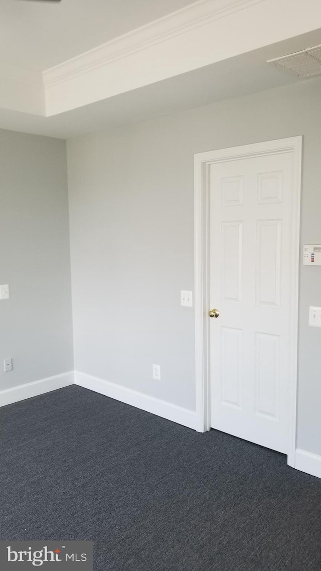 carpeted spare room with crown molding