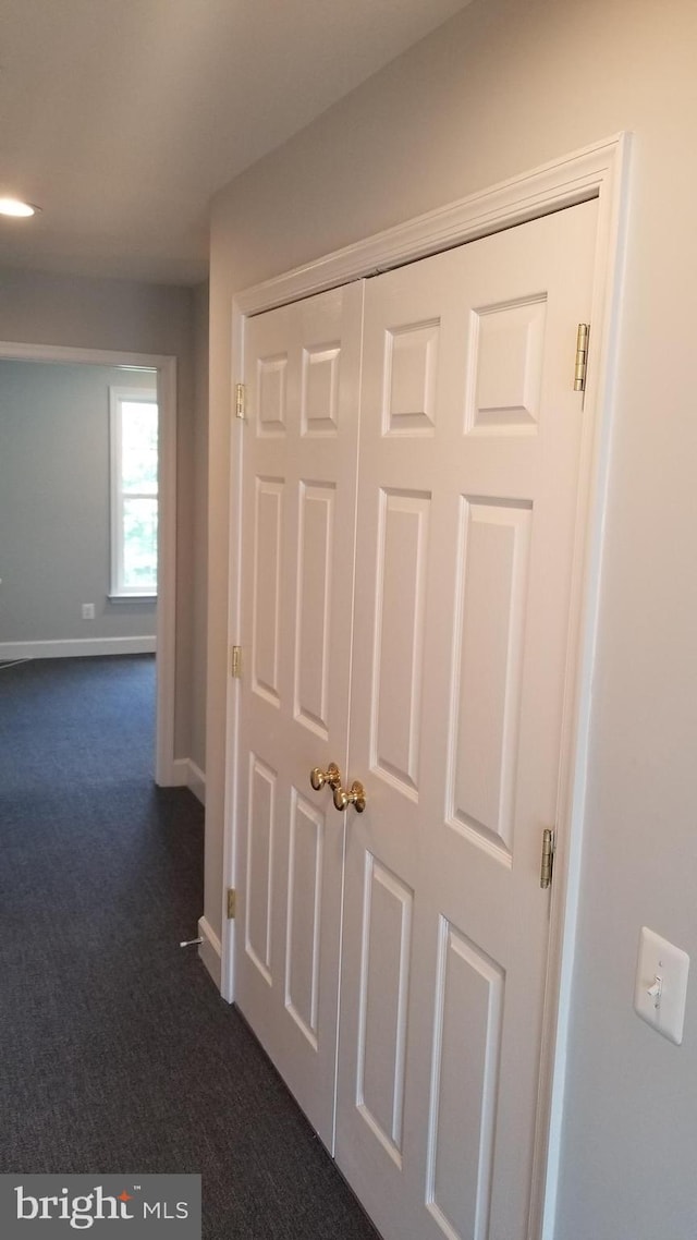 hallway with dark carpet