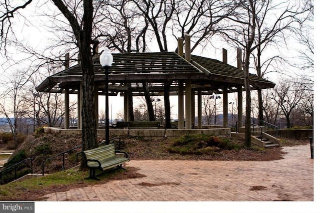 surrounding community featuring a gazebo and a water view