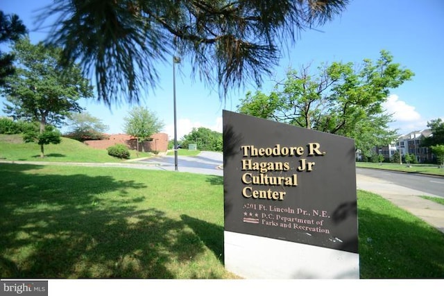 community / neighborhood sign with a lawn