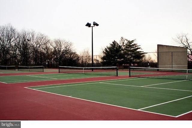 view of tennis court with basketball hoop