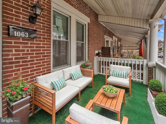 balcony featuring an outdoor living space and a porch