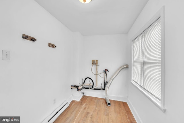 clothes washing area with hardwood / wood-style flooring and hookup for a washing machine