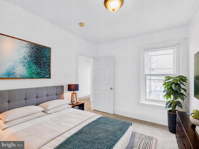 bedroom featuring light carpet