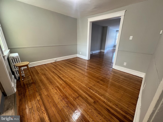 empty room featuring dark hardwood / wood-style flooring