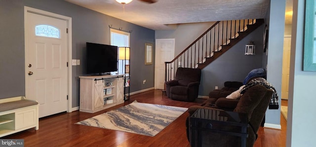 living room with ceiling fan and dark hardwood / wood-style floors