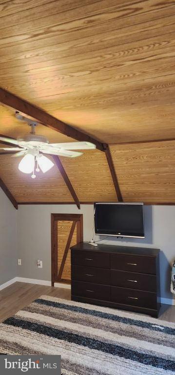 additional living space featuring wooden ceiling, wood-type flooring, and vaulted ceiling with beams