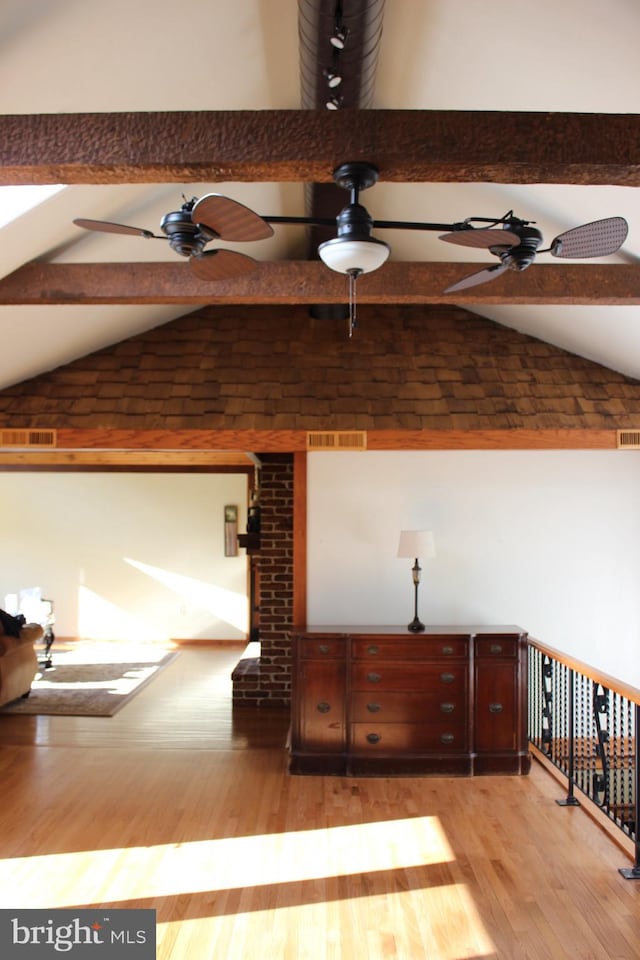 room details with ceiling fan, beamed ceiling, and hardwood / wood-style floors