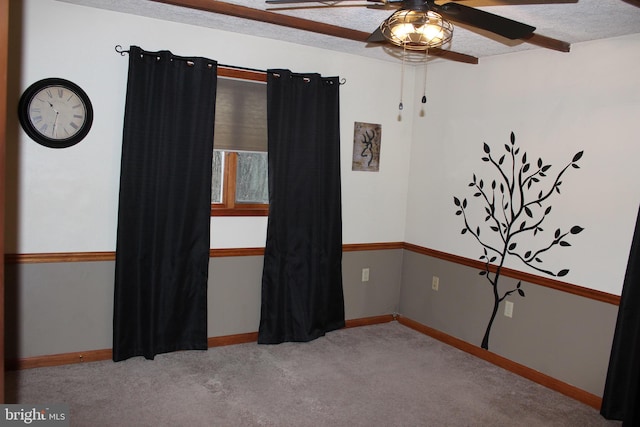 carpeted empty room with a textured ceiling and ceiling fan