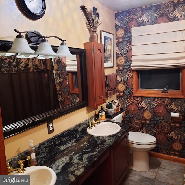 bathroom featuring toilet, vanity, and tile patterned floors